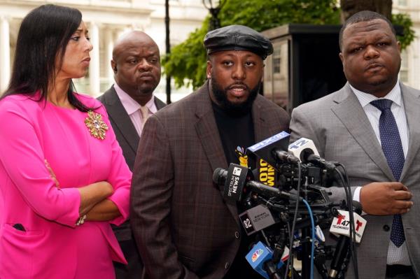 Shamel Kelly speaking at a news conference at New York's City Hall Park, accompanied by attorneys Bernarda Villalona and Harry Daniels