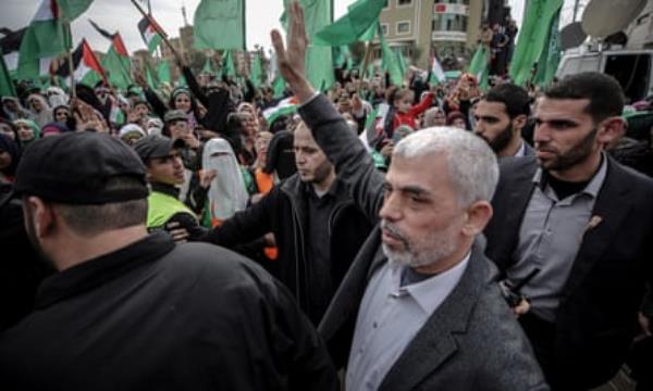 Yahya Sinwar waves to a crowd of supporters