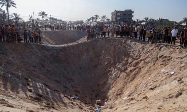Craters after Israeli airstrikes on a camp for displaced people